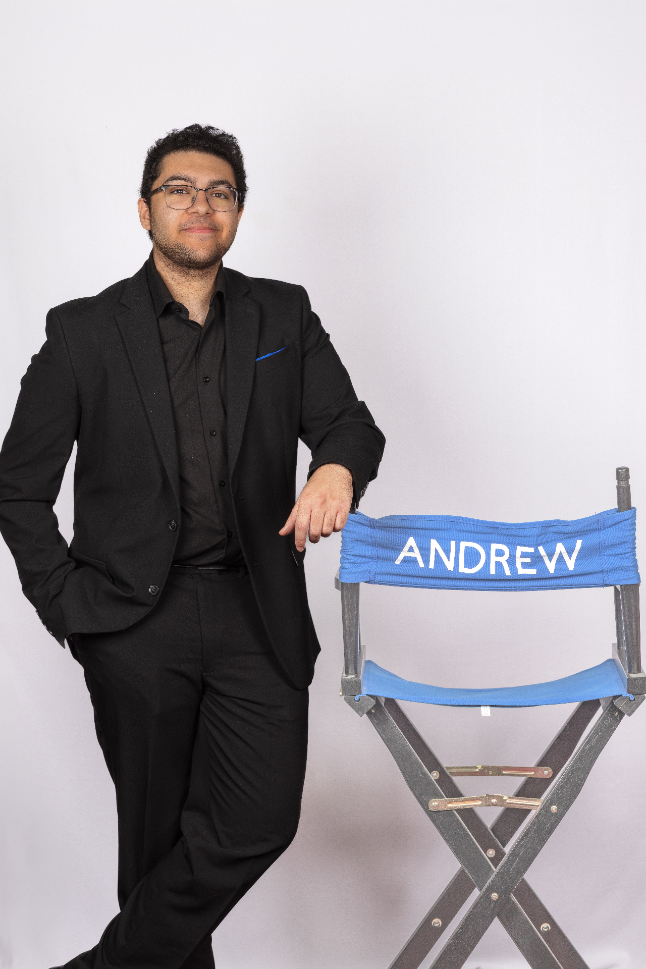Andrew Thomas leaning on a director's chair